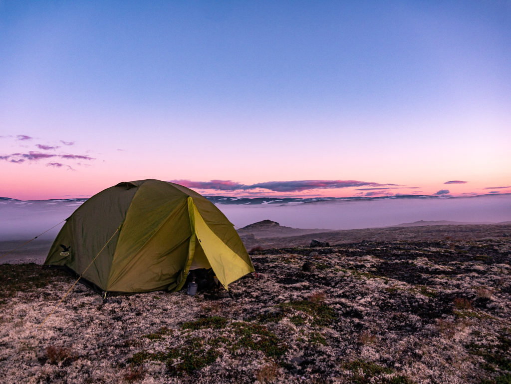 Ein Zelt, aufgenommen kurz vor dem Sonnenaufgang. Gutes Campingequipment darf auf der Packliste Island Radtour nicht fehlen.