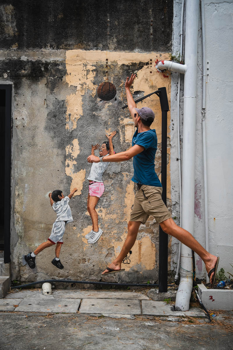 Tobi spielt Basketball an einem Street Art in George Town